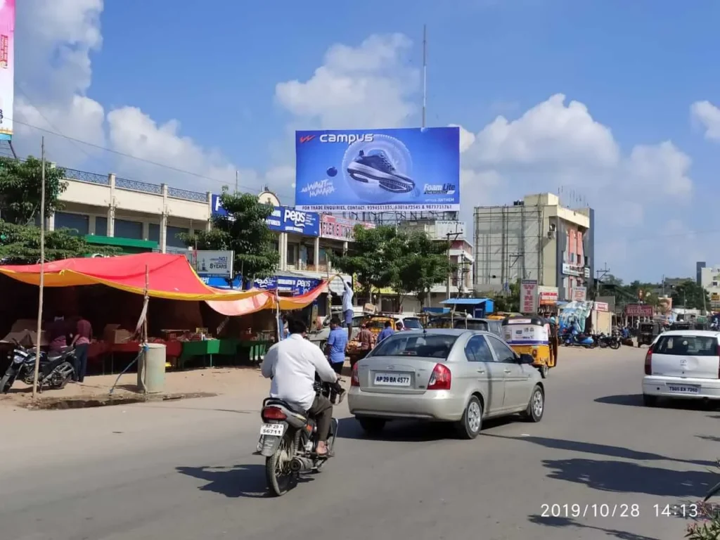 Large outdoor hoarding advertising displayed on a busy Delhi street, capturing the attention of commuters and showcasing a vibrant brand message