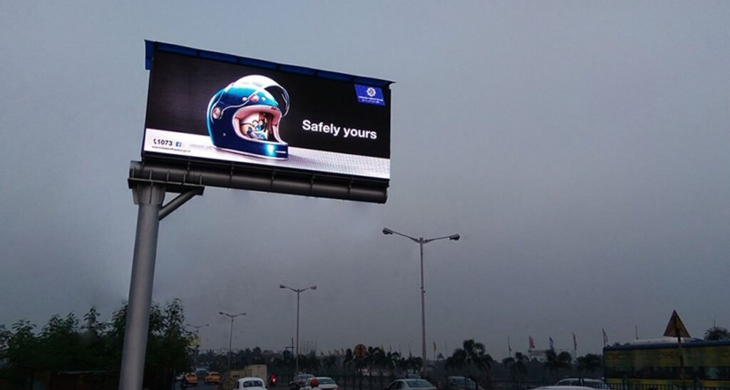 Large billboard ad on busy street, showcasing effective hoarding company outdoor advertising.