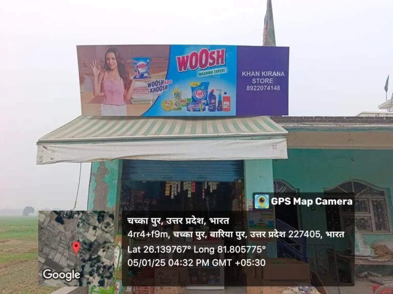 Dealer board displayed above a local grocery shop, showcasing branded products for outdoor retail advertising.