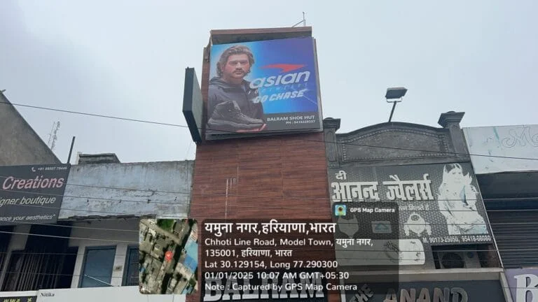 Dealer board displayed above a local grocery shop, showcasing branded products for outdoor retail advertising.