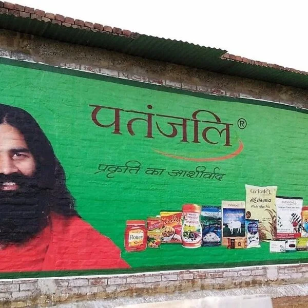 Digital wall painting by ACME Advertising Co. on an urban wall in India, featuring vibrant artwork, Hindi text, and bold visuals for outdoor brand promotion.