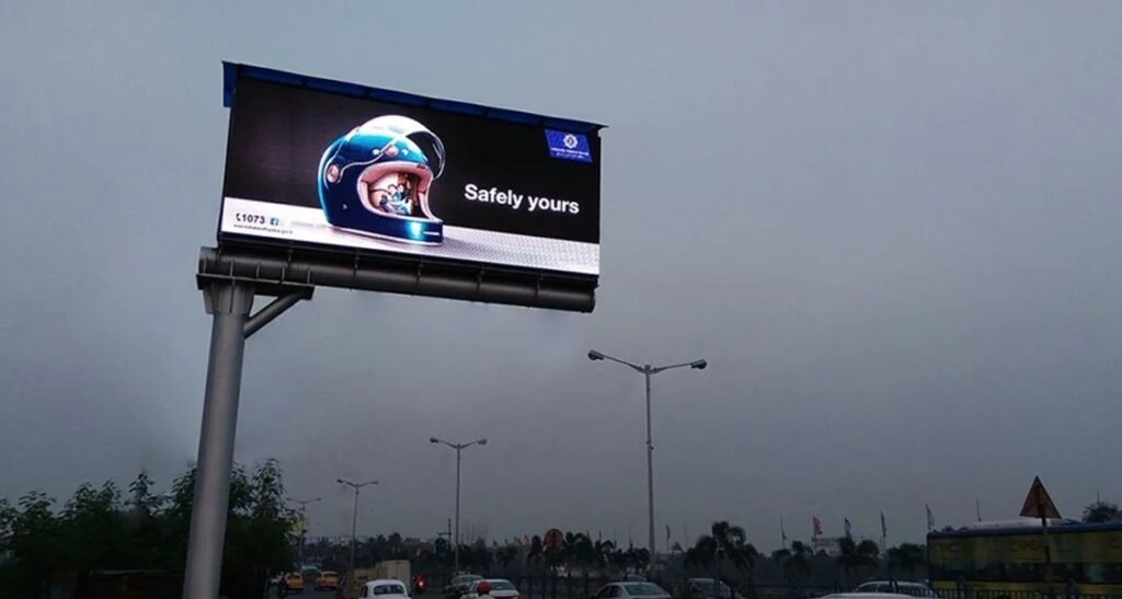 Digital billboard advertising on a busy Delhi highway featuring a luxury brand campaign.