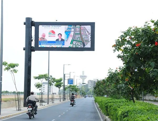 Digital billboard advertising on a busy Delhi highway featuring a luxury brand campaign.