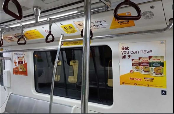 Fortune and Kitchenmate food product ads displayed inside a Bengaluru Metro train, installed by Acme Advertising Co. for daily commuter engagement.